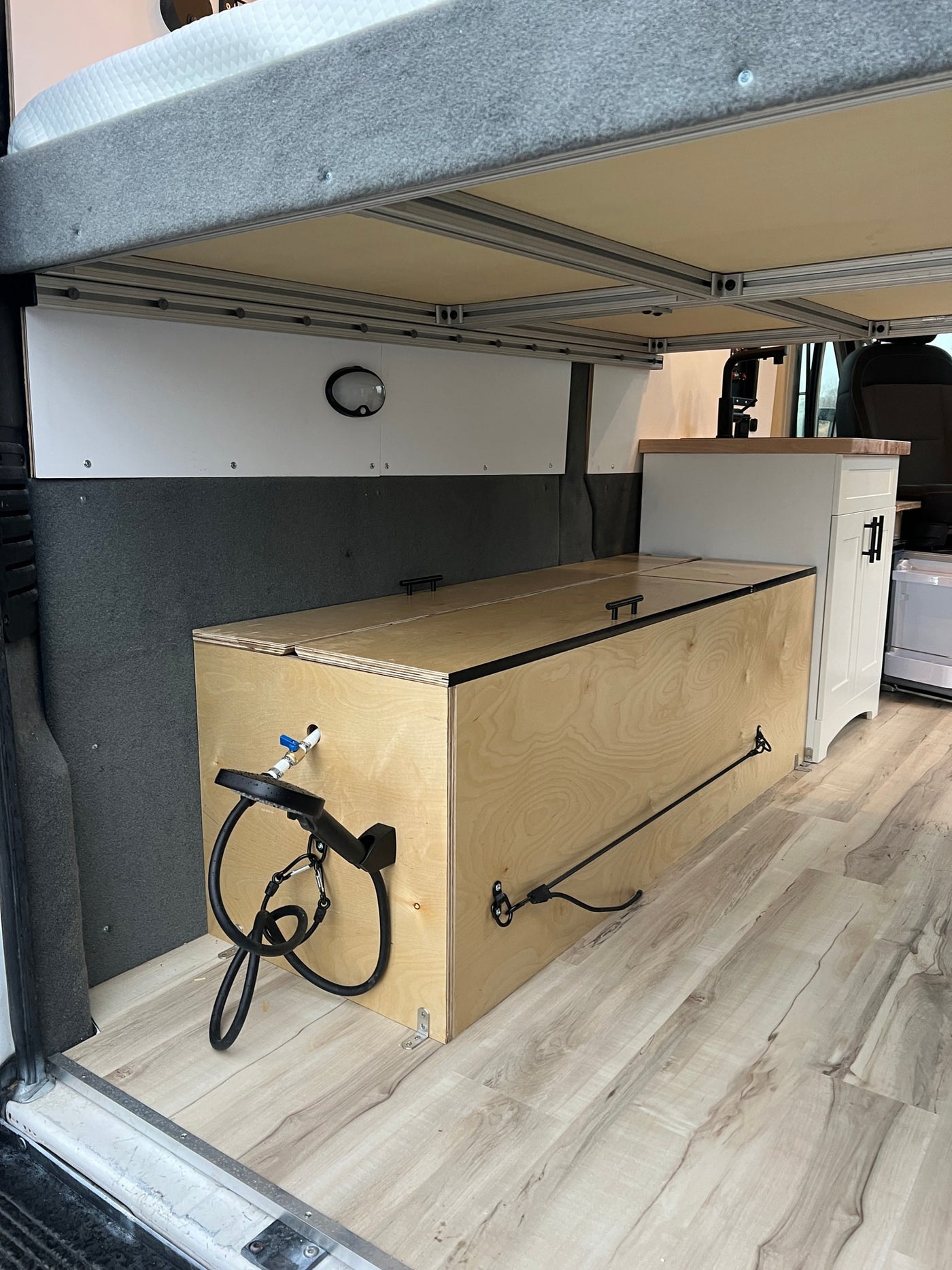  and front seats. Ready for your next adventure.|RV rental: Spacious camper van interior with raised bed — photo 6