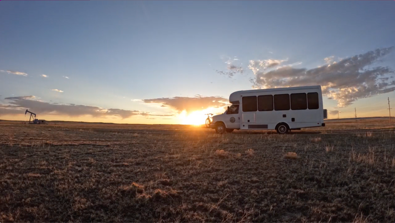 RV rental: White camper van with bike at sunset in a vast, dry landscape with a distant oil pumpjack. Your next adventure! — photo 2