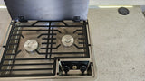 An RV rental kitchen features a Dometic 2-burner gas cooktop with open lid and integrated wireless phone charger.