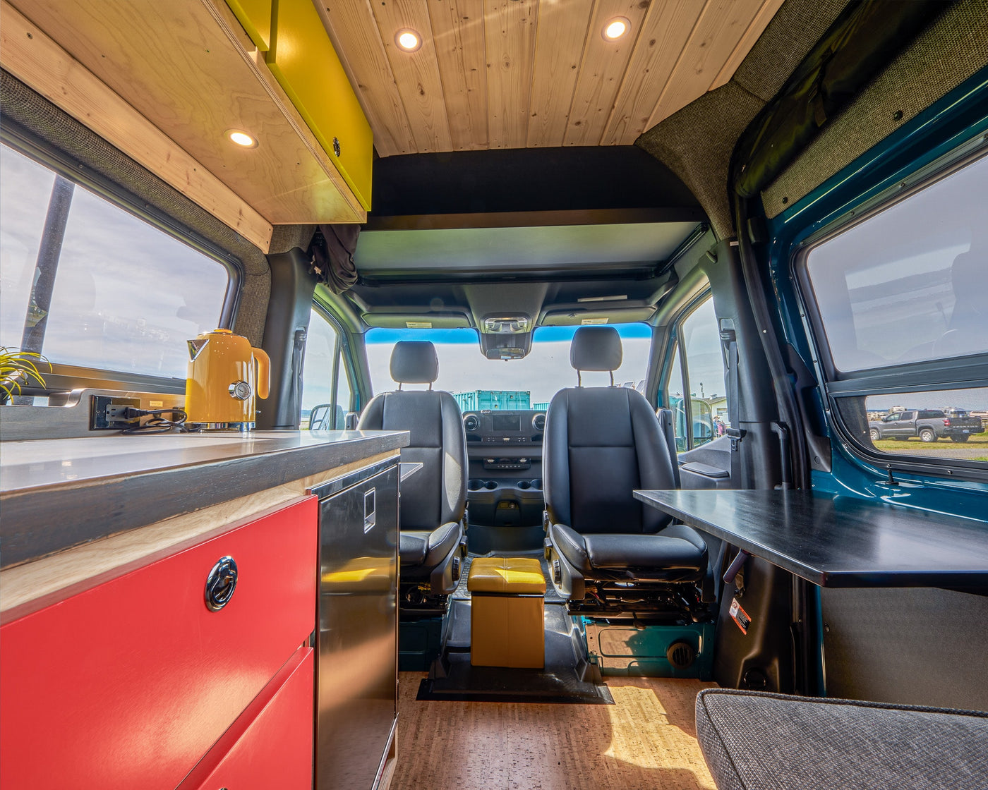 Spacious custom RV rental interior with kitchen, seating, and wood accents, ready for adventure. — photo 9