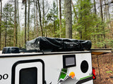 RV rental camper featuring a Freespirit rooftop tent and Winegard antenna, perfect for forest camping adventures.