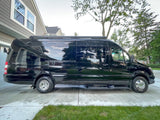 This black Coachmen Galleria luxury RV is ready for your next rv rental adventure, parked on a residential driveway.