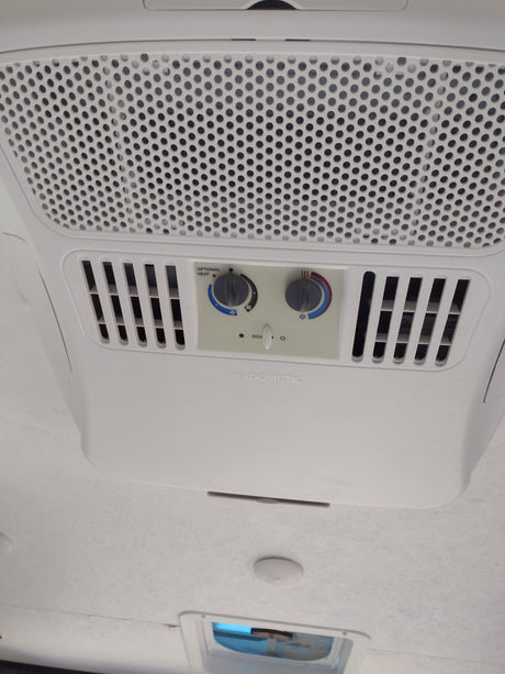 RV rental climate control unit: A Dometic air conditioner and heater with adjustable settings visible on the ceiling.