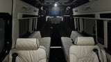 Premium rv rental interior with facing quilted seats, ceiling speakers, and entertainment screen for comfort.
