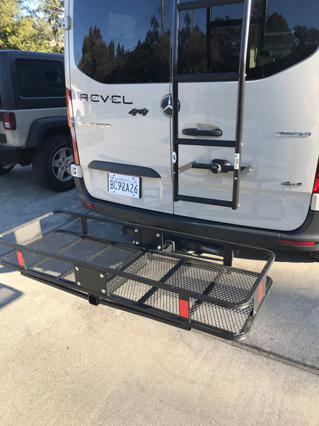 This Mercedes-Benz Sprinter Revel 4x4 camper van, equipped with a rear cargo carrier, is perfect for an RV rental.