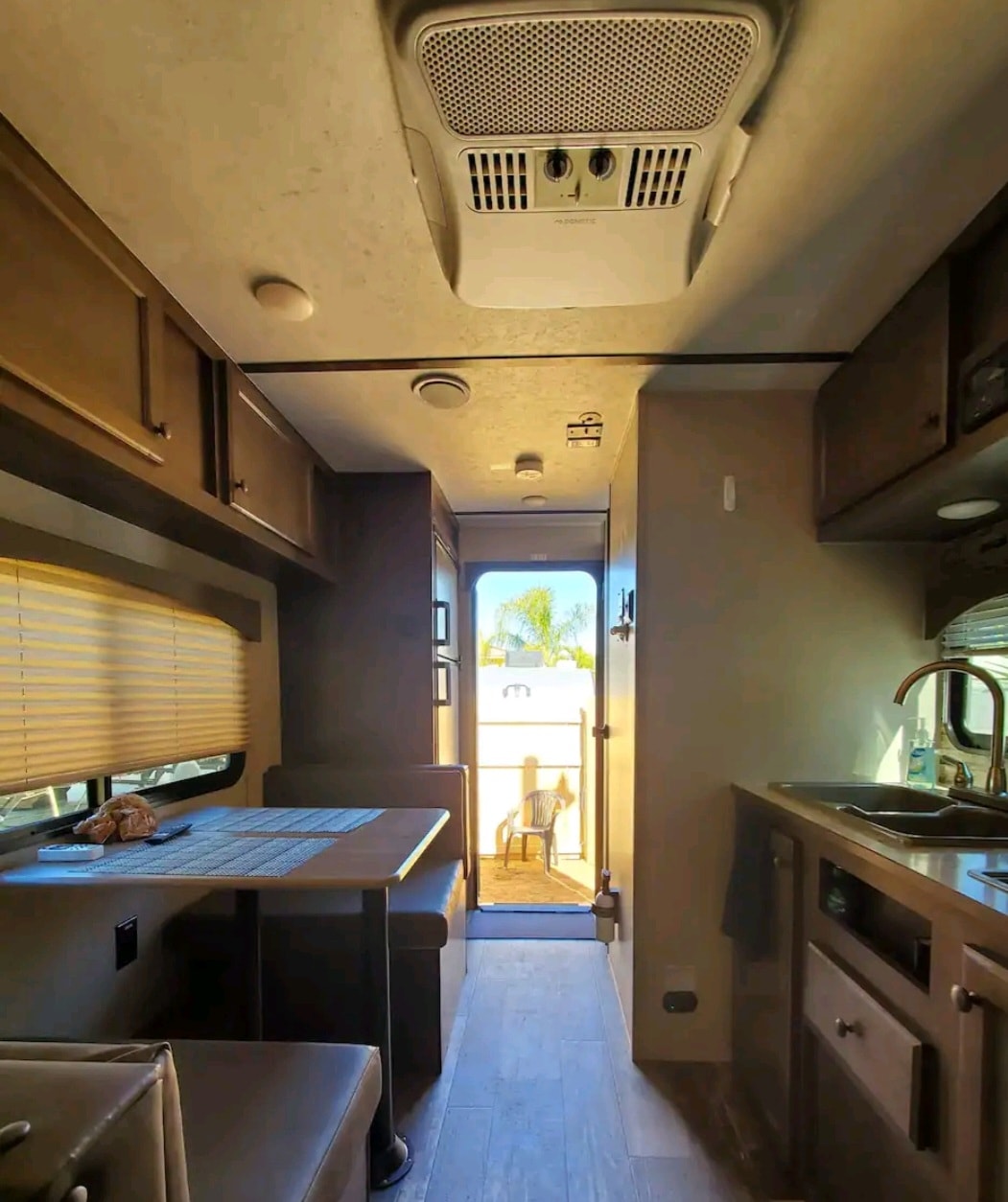 RV rental interior: AC unit, kitchen, dinette, and bright entrance. Ready for your mobile adventure! — photo 10