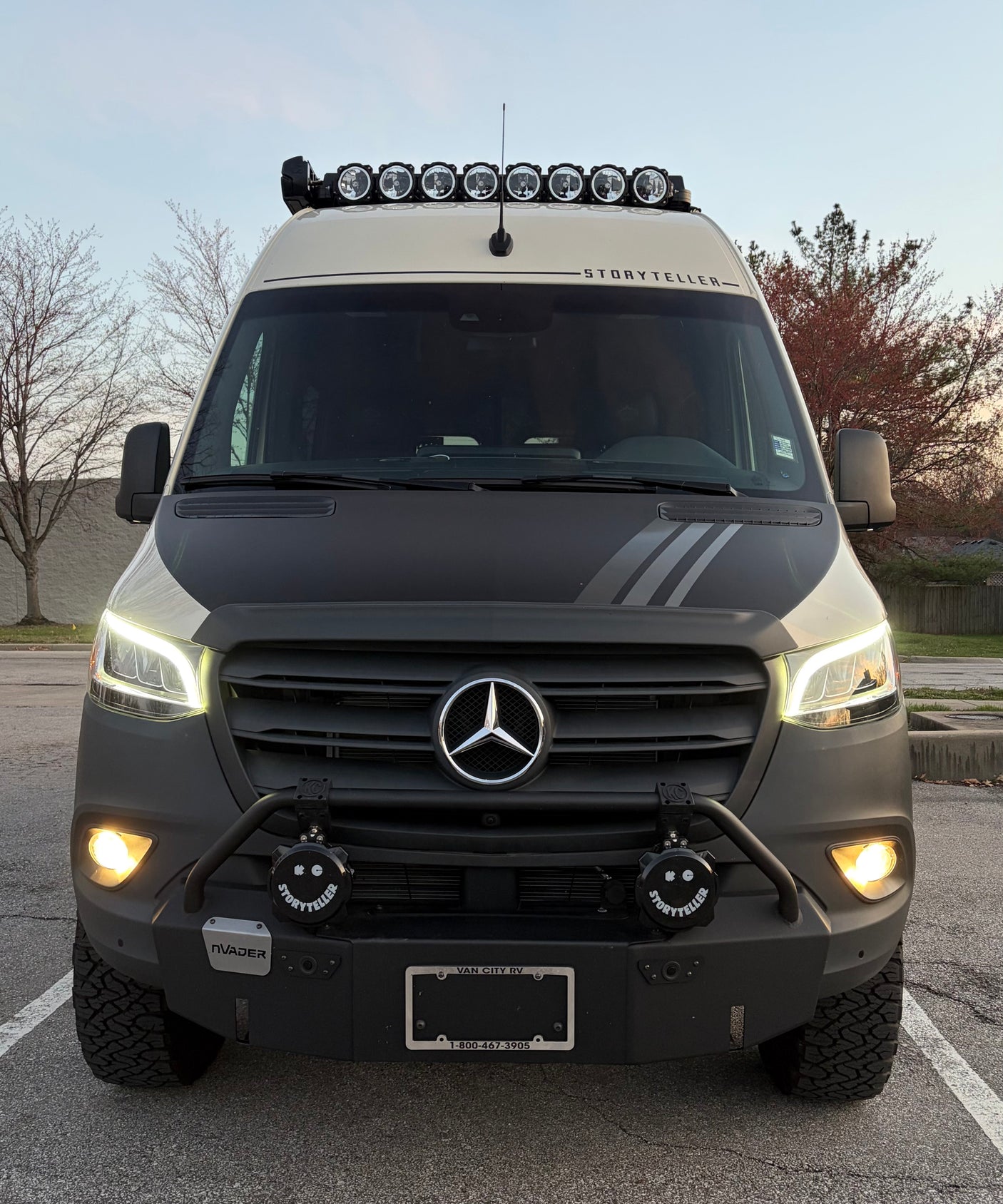 This rugged Mercedes-Benz Storyteller Sprinter van rv rental boasts roof lights, a custom bumper, and all-terrain tires.