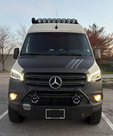 This rugged Mercedes-Benz Storyteller Sprinter van rv rental boasts roof lights, a custom bumper, and all-terrain tires.