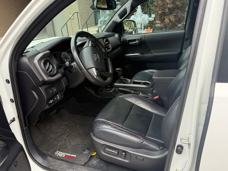Driver's view of a clean, modern truck's black interior with leather seats, dashboard, and steering wheel. A comfortable alternative to an rv rental. — photo 9