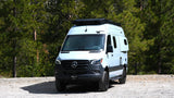 Adventure-ready Mercedes Sprinter camper van on a dirt road, perfect for your next RV rental exploration in the forest.