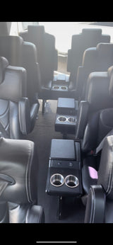 Experience comfortable group travel! Spacious black leather seating and cup holders inside this luxury RV rental.