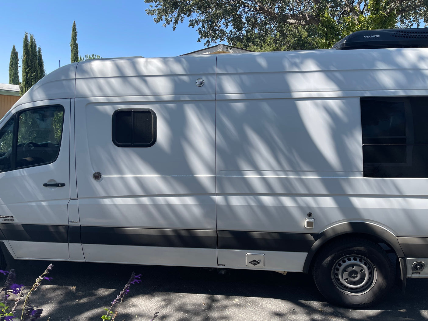 White Mercedes Sprinter camper van, a perfect rv rental for road trips. Features include Dometic AC & propane access.