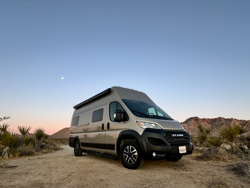 RV rental camper van on a desert road at dusk or dawn — photo 1