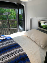 Relax in this cozy RV rental bed. Enjoy the outdoor view & sunlight from your mobile bedroom retreat.