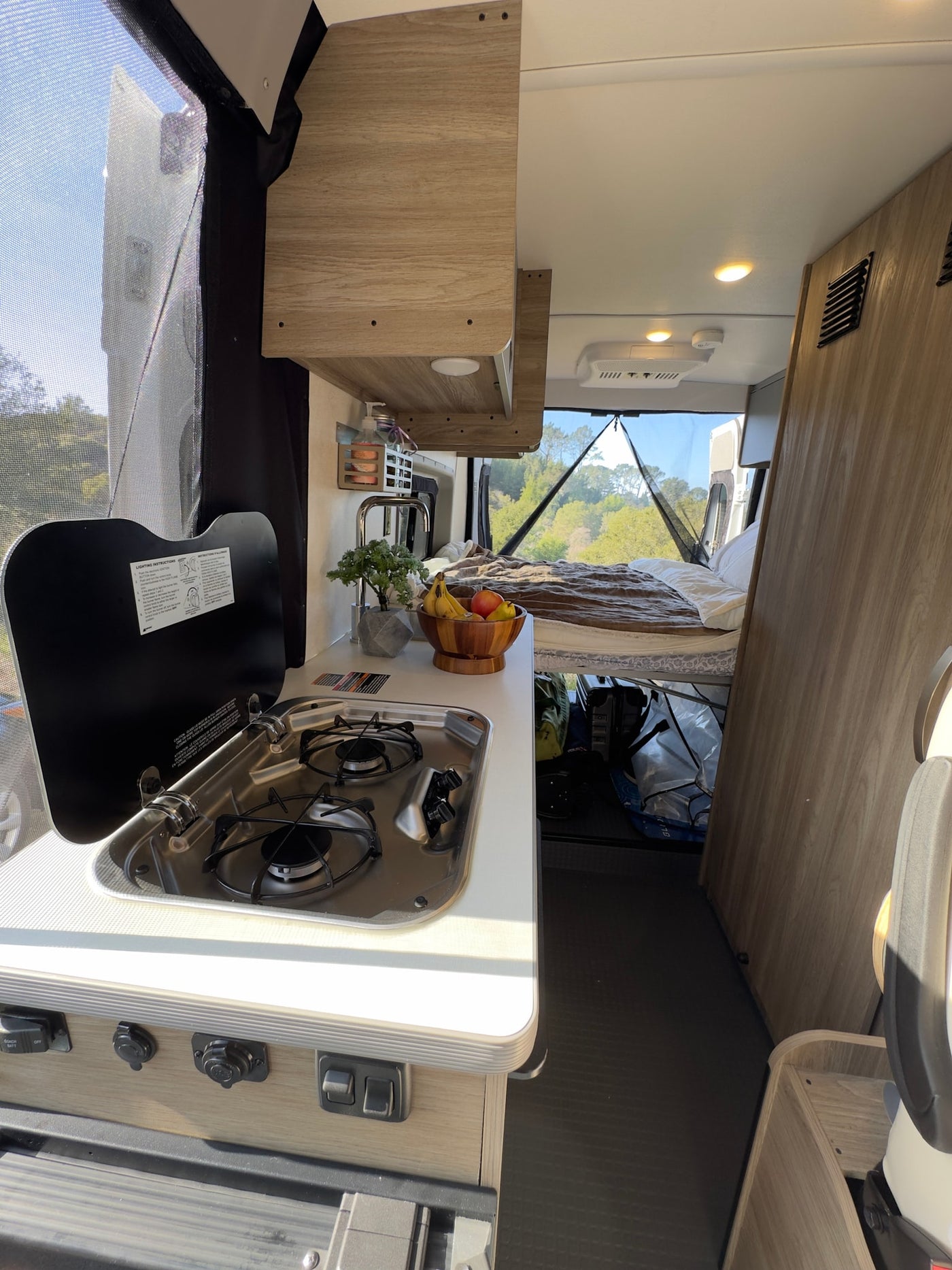  and hand soap on a light counter.|This rv rental offers a fully equipped kitchen — photo 7