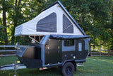 Rugged dark grey off-road camper trailer with pop-top tent, ready for your next RV rental adventure.