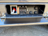 RV rental: detailed view of the utility bay with fresh/city water, black/gray tank, and cable hookup panel.