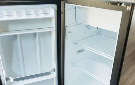This clean, empty refrigerator inside an RV rental is ready for your food and drinks. Ideal for road trips!