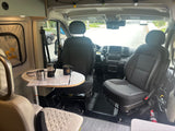 Cozy RV rental interior with front seats swiveled, table set for coffee & maps. Perfect for a road trip adventure!