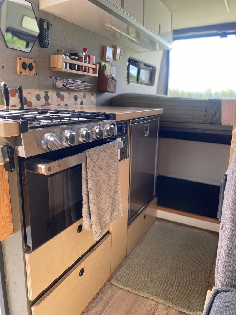  overlooking vast golden plains. Perfect for an outdoor adventure.|Cozy RV rental kitchen with stove — photo 2