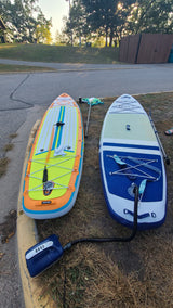 Two vibrant inflatable paddleboards with an electric pump, ready for an RV rental adventure!
