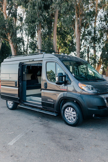 Gray Tofino conversion van, side door open, showing interior. Perfect for your next RV rental road trip.