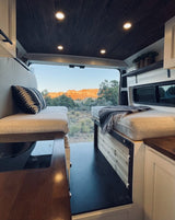 This cozy RV rental provides stunning desert mountain views from its open rear doors for your van life journey.