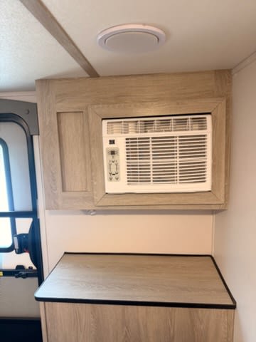  rugged wheels & roof rack for adventures.|Explore in this white and black XPLORER travel trailer RV rental — photo 7