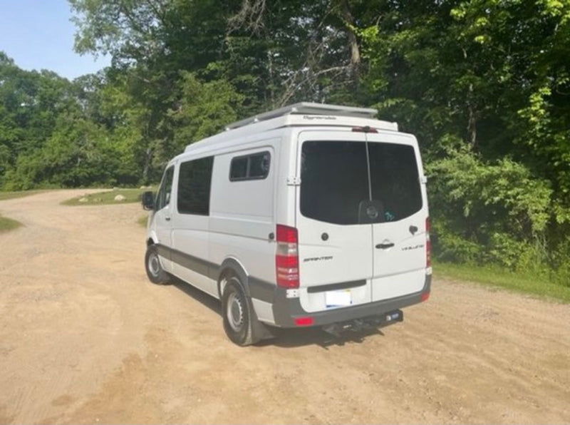  and a serene window view of nature.|Versatile camper van interior for RV rental — photo 15