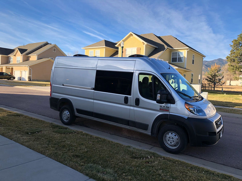  enjoying the view from their camper van.|An RV rental's camper van interior features a modern kitchen — photo 6