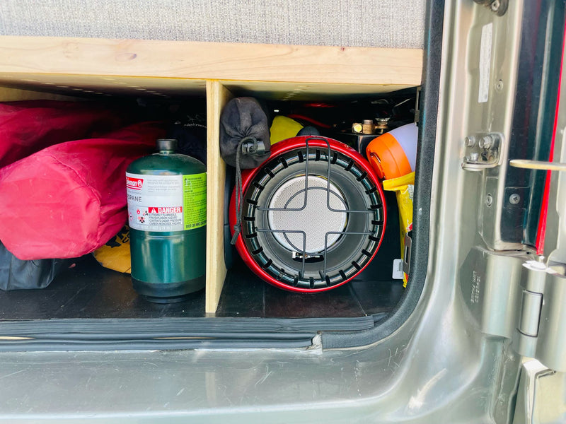  built into custom blue cabinetry with an open drawer.|Cozy RV rental kitchen with golden faucet — photo 15