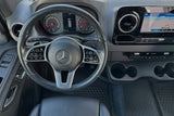 RV rental interior: Mercedes-Benz dashboard, steering wheel, digital display, and navigation screen.