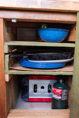 RV rental kitchen cabinet with camping dishes, a stove, and propane. Great for meal prep!