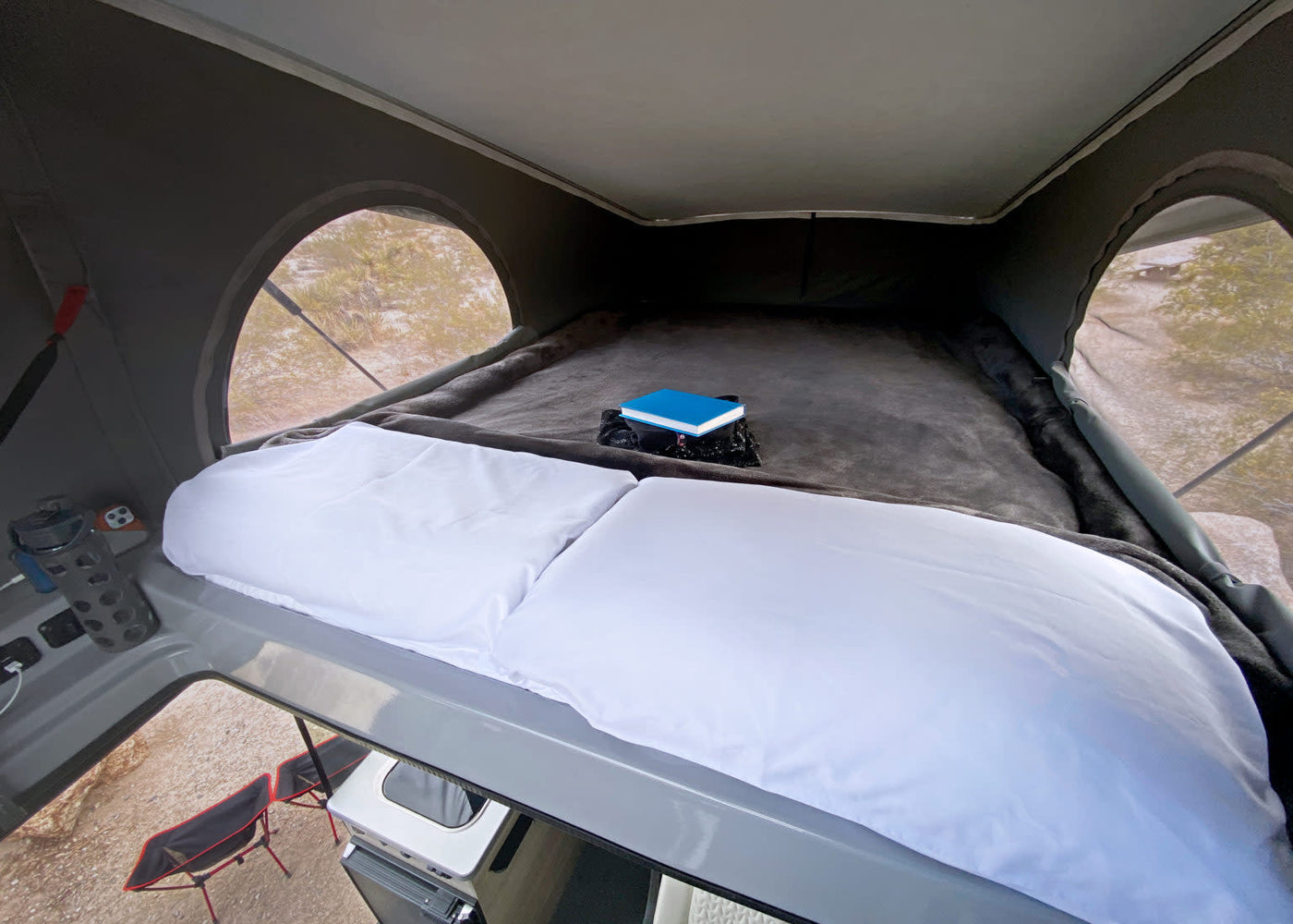  and kitchen with a view. Perfect for travel.|RV rental van interior with a bed — photo 11
