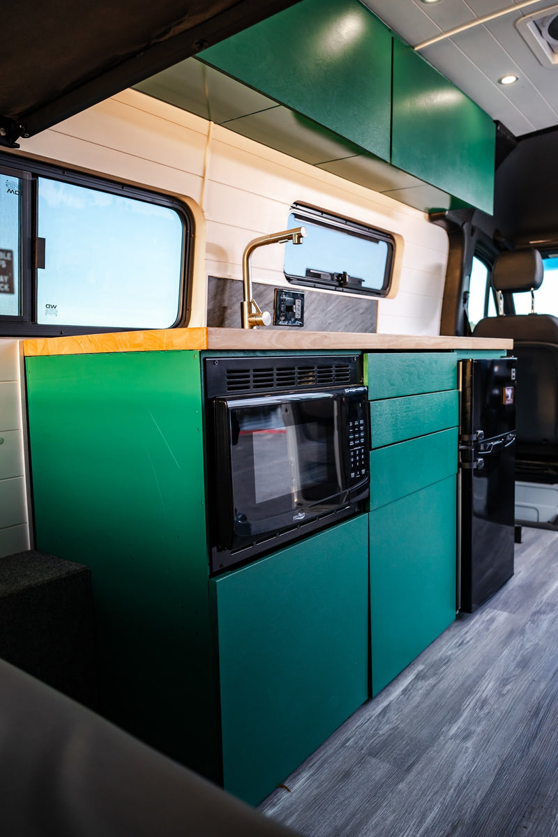  and accessibility hand controls visible.|**RV rental** interior showcasing the modern cockpit & a scenic lake view with a "Danger Unstable Cliffs" sign.|Driver's cockpit of an accessible Mercedes-Benz van for rv rental — photo 20