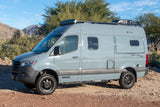 Explore the outdoors with this gray Winnebago Revel 4x4 camper van, perfect for an rv rental adventure.