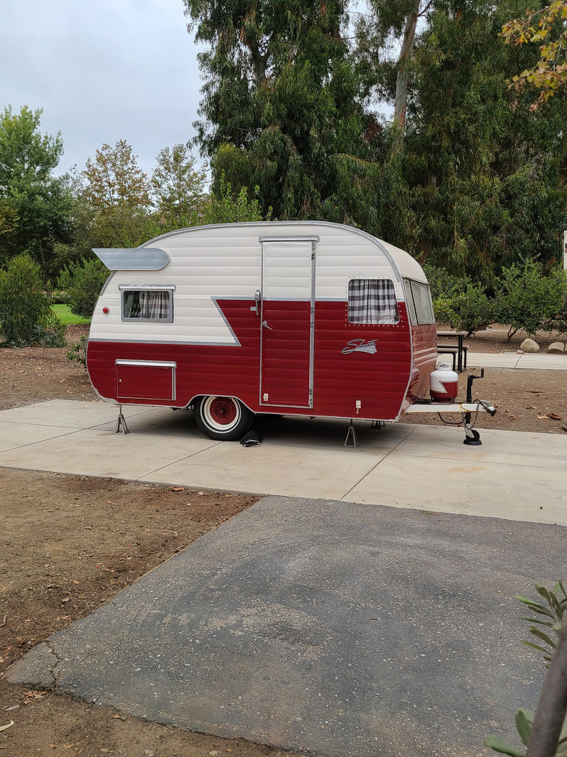 Retro red & white Shasta travel trailer, parked at a campsite, ready for your next RV rental adventure. — photo 2