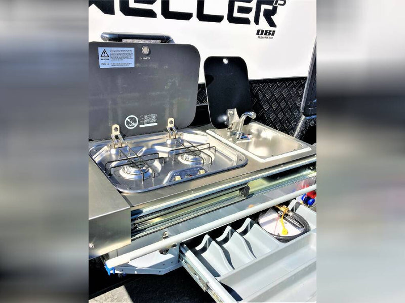  and a handy fold-down table.|Inside this RV rental: a compact dinette with a table and dark seating — photo 13