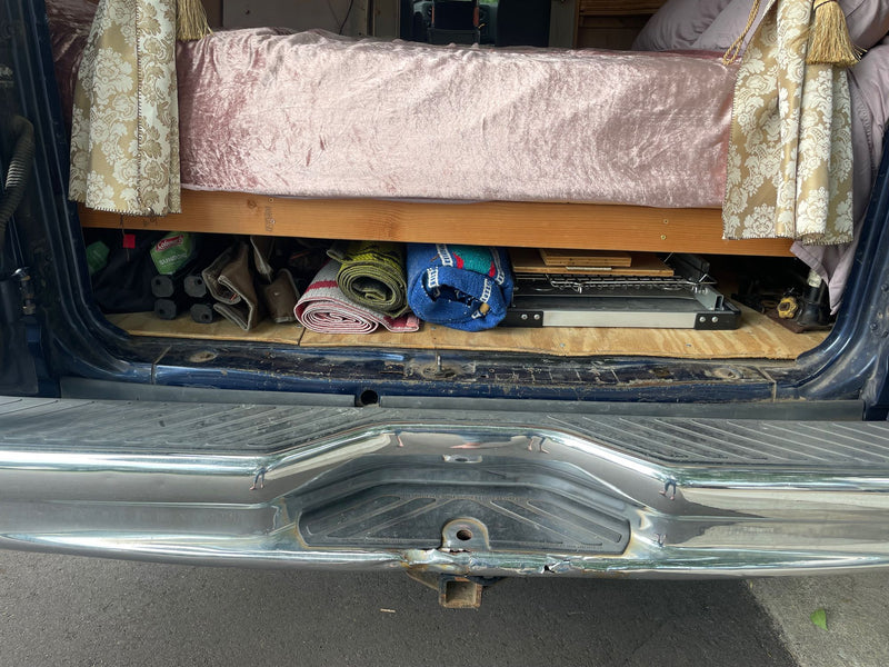  neatly organized in a wooden cabinet.|Cooking fresh meals from an **rv rental** van by a sunny lake. A woman relaxes at her mobile camp — photo 6