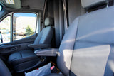 Comfortable front cabin of an RV rental, showcasing dark seats with armrests and a privacy divider behind them.