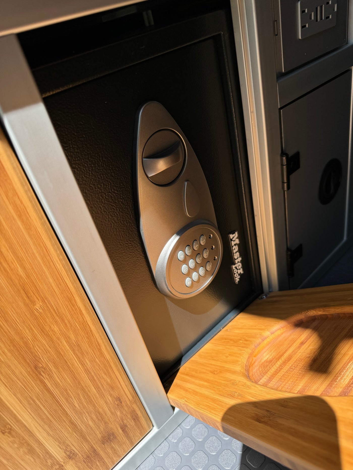 RV rental: Close-up of secure Master Lock safe with digital keypad, plus convenient USB outlets in bamboo interior. — photo 13