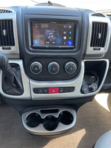 Inside an RV rental: a modern dashboard featuring a Pioneer multimedia display, climate controls, and multiple charging ports.