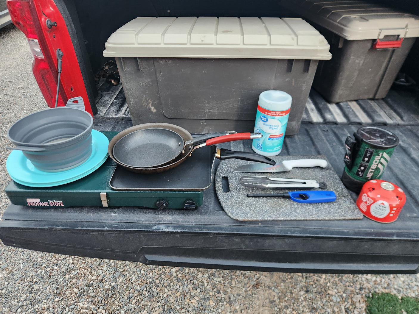 RV rental cooking gear: propane stove, pans, Jetboil, and wipes for camping meals.