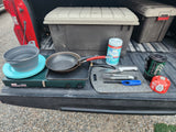 RV rental cooking gear: propane stove, pans, Jetboil, and wipes for camping meals.