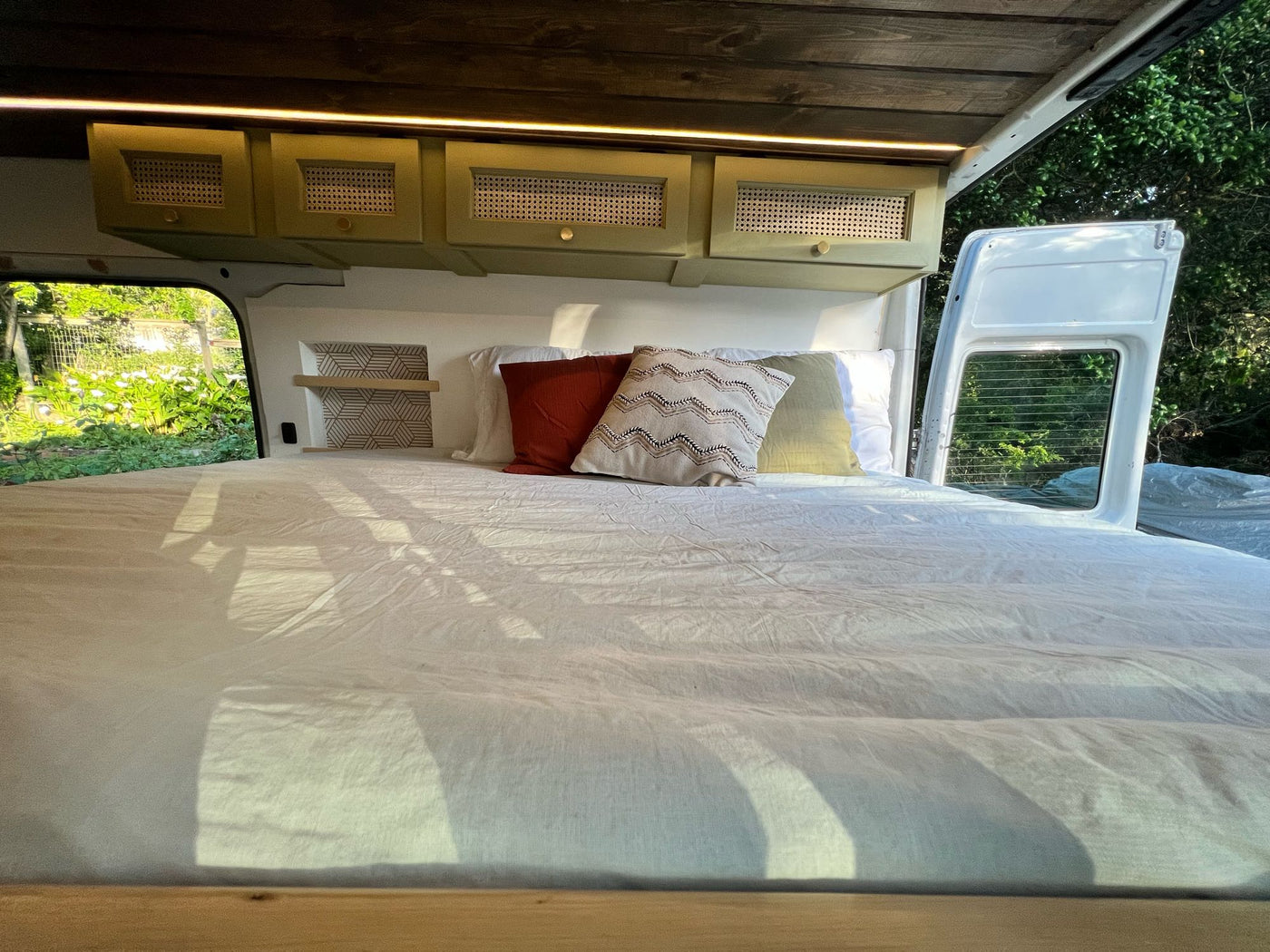  perfect for mobile living.|Cozy RV rental interior featuring a raised bed — photo 14