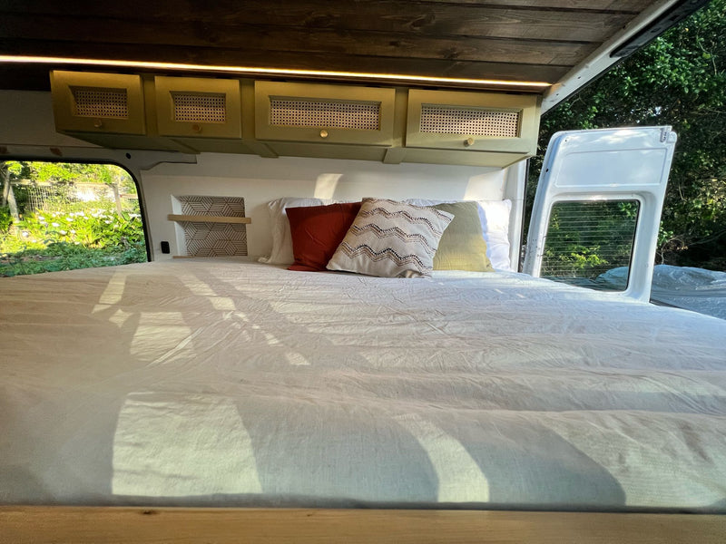  perfect for mobile living.|Cozy RV rental interior featuring a raised bed — photo 14