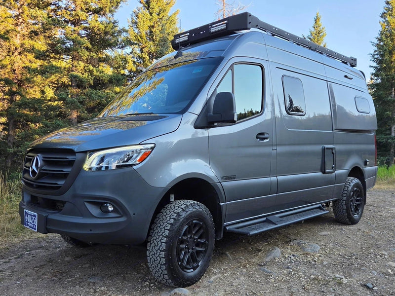 Gray Mercedes Sprinter Winnebago camper van with off-road tires & roof rack — photo 1