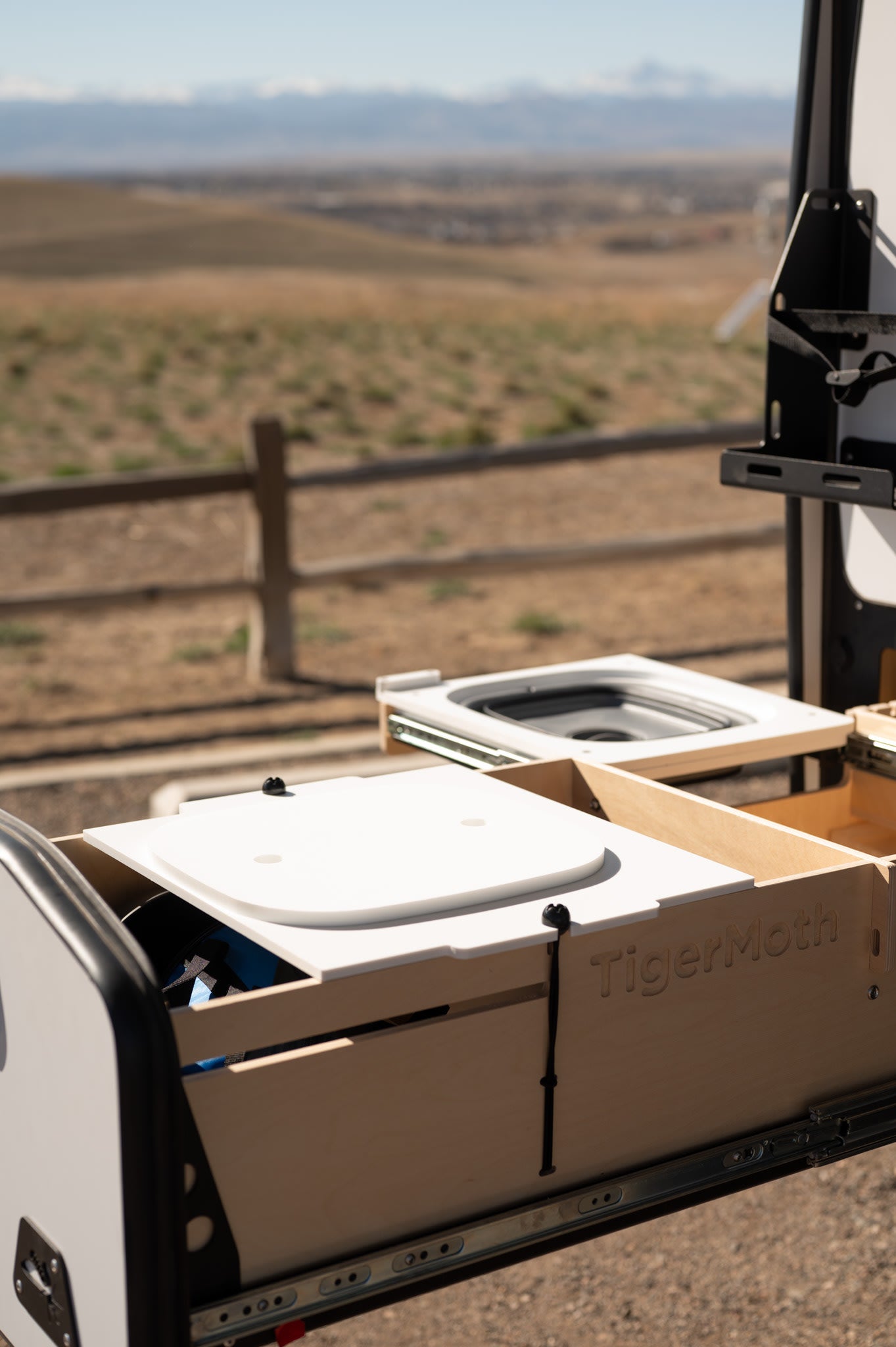 TigerMoth's compact mobile kitchen for RV rental. Features pull-out sink & storage, ideal for outdoor cooking.