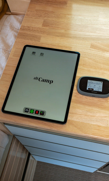 iPad showing 'alt Camp' and Verizon hotspot on a wood counter, providing mobile internet and entertainment for your RV rental.