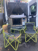 Relaxing outdoors with an RV rental! A cozy camper van with bug screen and two comfy chairs for your adventure.